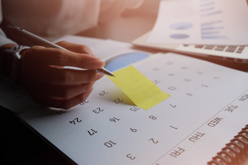 woman writing notes on a calendar