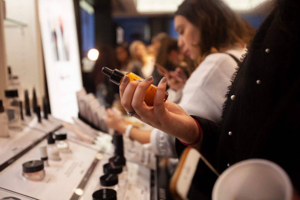 woman looking at a scent bottle