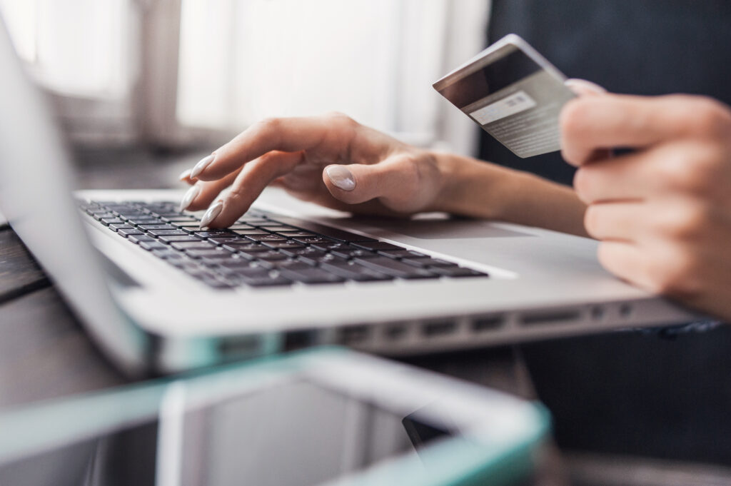 woman making purchase on laptop with credit card