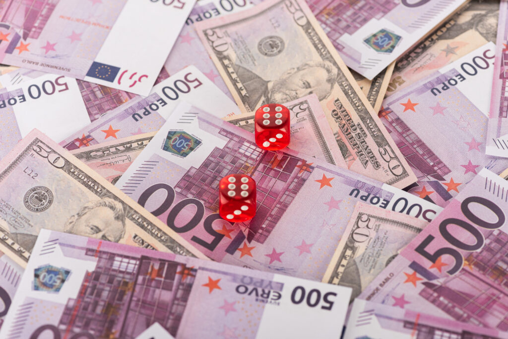 dice on euro and dollar banknotes, sports betting concept