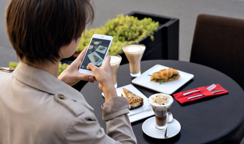 woman taking photo of her food