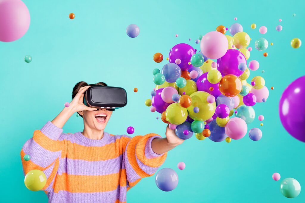 Woman using VR headset interacting with colourful bubbles