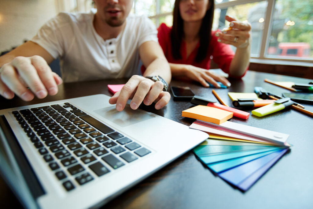 man and woman planning on a laptop