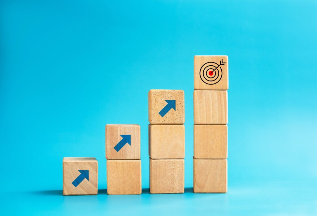 stacked wooden blocks with arrows and a target