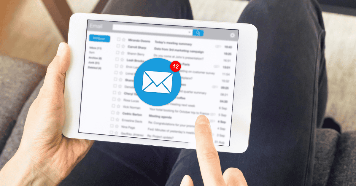 A person uses a tablet to check their email inbox, which shows multiple unread messages and a notification icon indicating 12 new emails.